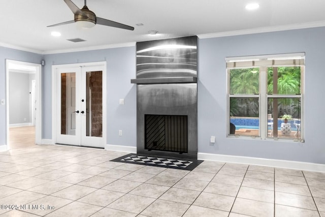 224 Bowles St, Neptune Beach, FL 32266 - unfurnished living room featuring french doors, ornamental molding, a ceiling fan, tile patterned floors, and a fireplace with flush hearth