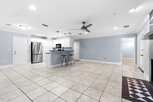 224 Bowles St, Neptune Beach, FL 32266 - kitchen featuring freestanding refrigerator, ornamental molding, a kitchen breakfast bar, ceiling fan, and dark countertops