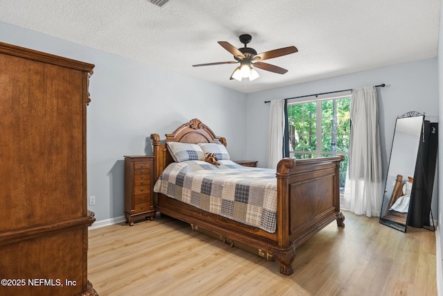 952 Long Lake Dr, Jacksonville, FL 32225 - bedroom with light wood-style flooring, a textured ceiling, and a ceiling fan
