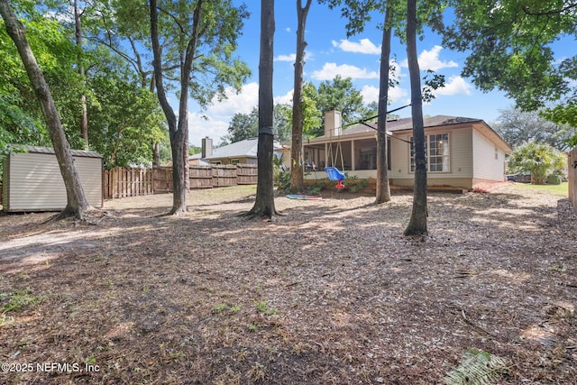 952 Long Lake Dr, Jacksonville, FL 32225 - view of yard featuring fence, a storage unit, an outdoor structure, and a sunroom