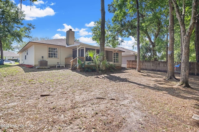 952 Long Lake Dr, Jacksonville, FL 32225 - back of property featuring a chimney, fence, a sunroom, and central AC