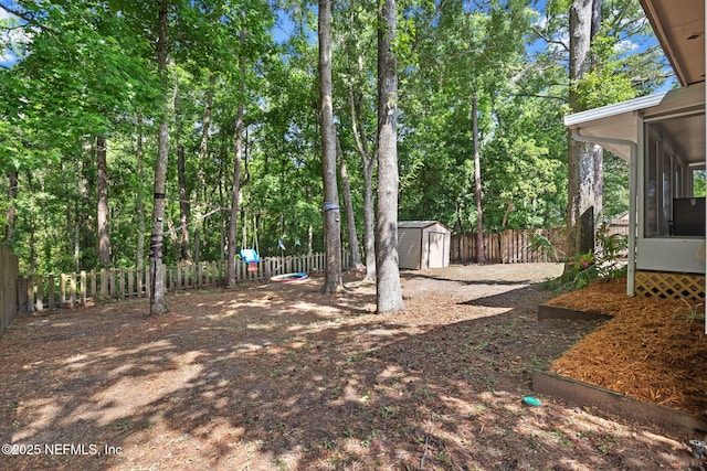 952 Long Lake Dr, Jacksonville, FL 32225 - fenced backyard with a sunroom, a storage unit, and an outdoor structure