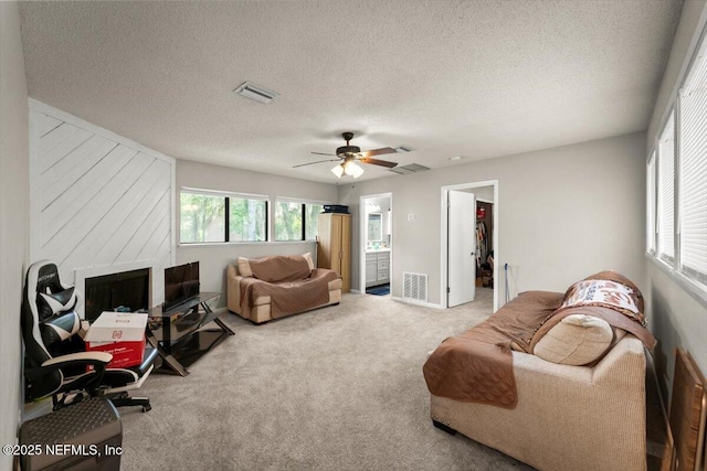2438 Sylvan Chase Dr, Orange Park, FL 32073 - carpeted living room featuring a ceiling fan and a textured ceiling
