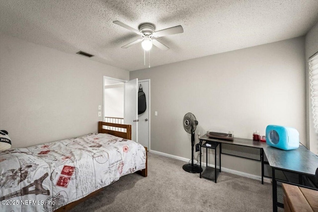 2438 Sylvan Chase Dr, Orange Park, FL 32073 - carpeted bedroom with a textured ceiling, ceiling fan, and baseboards