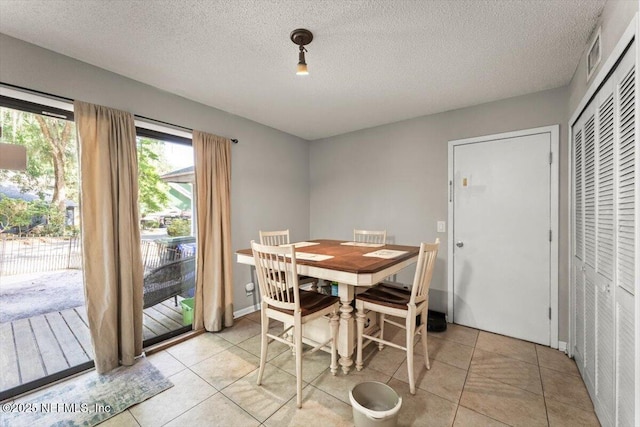 2438 Sylvan Chase Dr, Orange Park, FL 32073 - dining area with a textured ceiling and light tile patterned floors