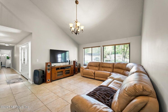 2438 Sylvan Chase Dr, Orange Park, FL 32073 - living area with a chandelier, light tile patterned floors, high vaulted ceiling, and baseboards