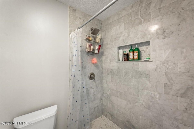 2438 Sylvan Chase Dr, Orange Park, FL 32073 - bathroom with tiled shower, toilet, and a textured ceiling