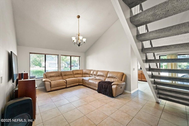 2438 Sylvan Chase Dr, Orange Park, FL 32073 - living area with light tile patterned floors, high vaulted ceiling, a chandelier, baseboards, and stairs