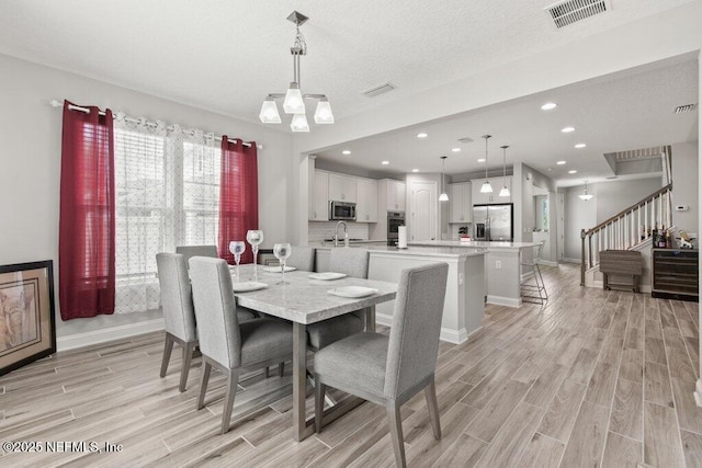 dining room featuring wood finish floors, stairs, baseboards, and recessed lighting