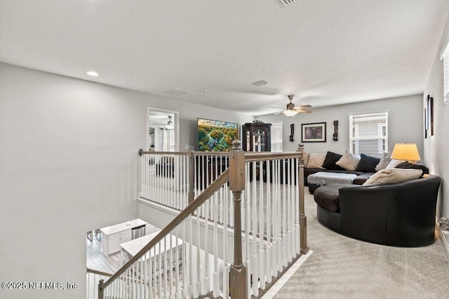 carpeted living room with ceiling fan