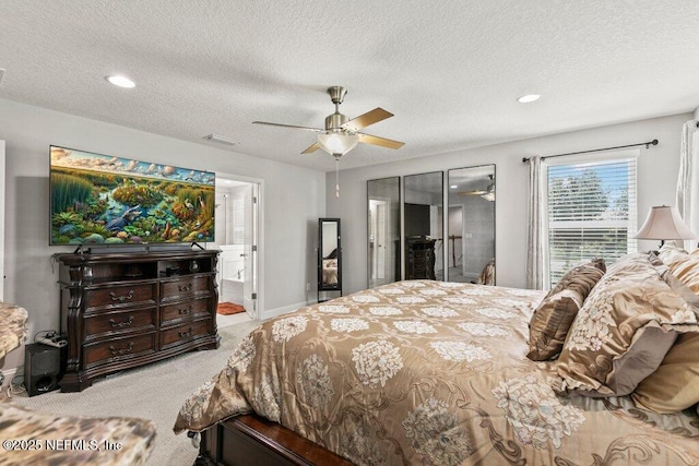 carpeted bedroom with a textured ceiling, recessed lighting, and a ceiling fan