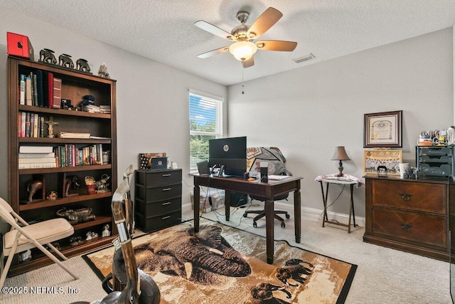 home office featuring ceiling fan, carpet, a textured ceiling, and baseboards