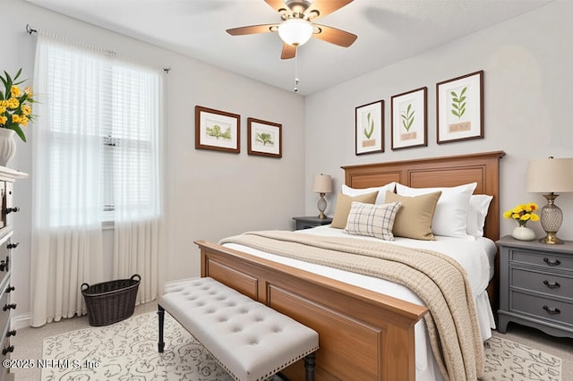 bedroom with light carpet and ceiling fan