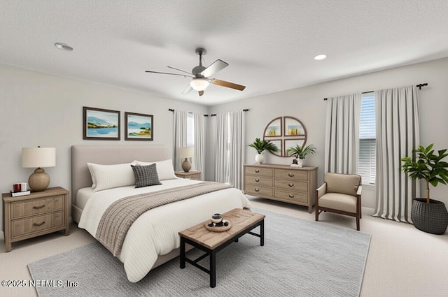 bedroom featuring light carpet, ceiling fan, recessed lighting, and a textured ceiling