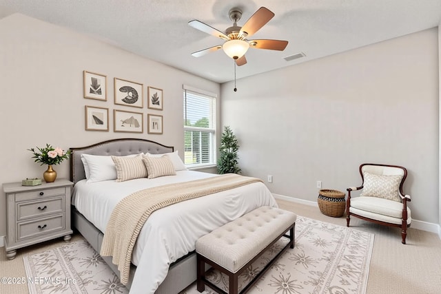 bedroom featuring baseboards, light colored carpet, and ceiling fan