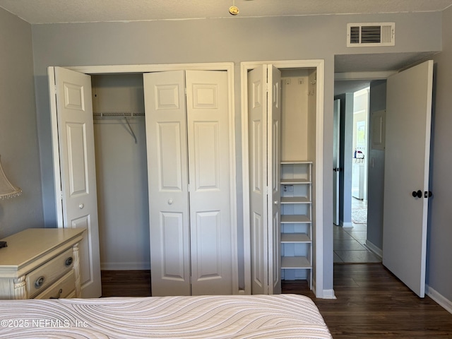 bedroom with dark wood-style flooring and baseboards