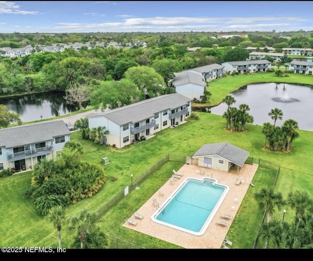 drone / aerial view of a nearby body of water and a pool area