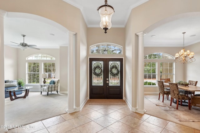 2214 Links Dr, Fleming Island, FL 32003 - foyer entrance featuring ornate columns, arched walkways, ornamental molding, and plenty of natural light