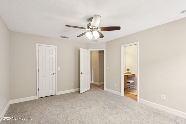 2214 Links Dr, Fleming Island, FL 32003 - unfurnished bedroom with carpet floors, baseboards, connected bathroom, and a ceiling fan