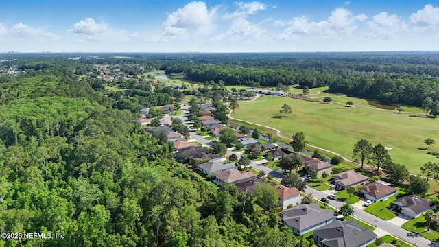 4956 Cypress Links Blvd, Elkton, FL 32033 - aerial view of property and surrounding area featuring a heavily wooded area, a golf course, and nearby suburban area