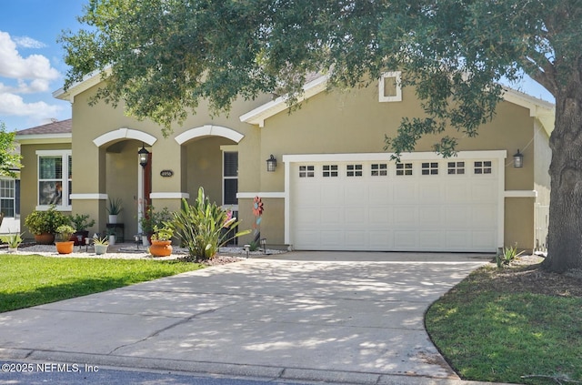 4956 Cypress Links Blvd, Elkton, FL 32033 - view of front of house featuring an attached garage, concrete driveway, and stucco siding