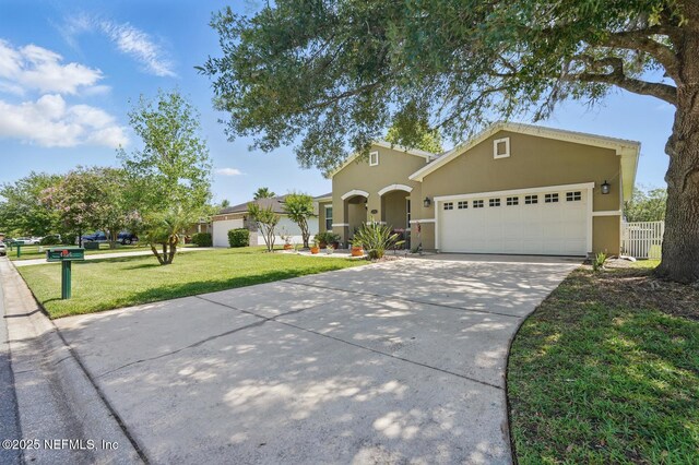 4956 Cypress Links Blvd, Elkton, FL 32033 - view of front facade with stucco siding, driveway, and an attached garage