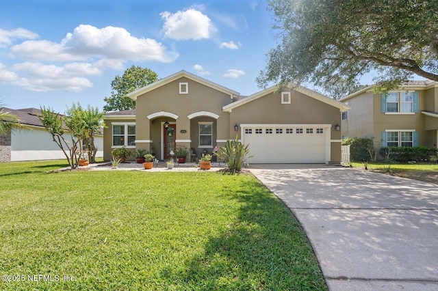 4956 Cypress Links Blvd, Elkton, FL 32033 - traditional home featuring stucco siding, an attached garage, driveway, and a front lawn