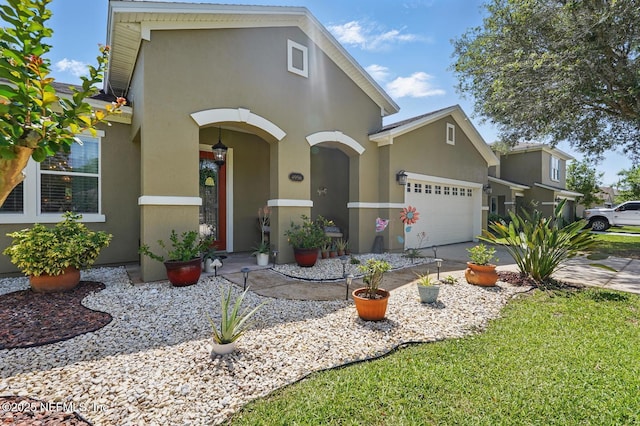 4956 Cypress Links Blvd, Elkton, FL 32033 - view of front of house featuring stucco siding, an attached garage, and concrete driveway