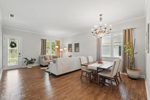 4956 Cypress Links Blvd, Elkton, FL 32033 - dining room with a chandelier, wood finished floors, crown molding, and baseboards