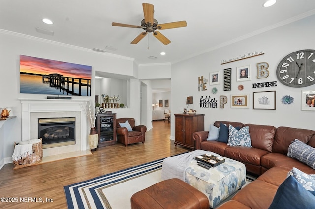 4956 Cypress Links Blvd, Elkton, FL 32033 - living room featuring ceiling fan, crown molding, wood finished floors, recessed lighting, and a fireplace with flush hearth