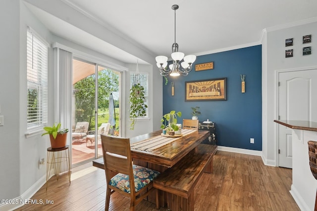 4956 Cypress Links Blvd, Elkton, FL 32033 - dining area featuring a chandelier, baseboards, hardwood / wood-style floors, and ornamental molding