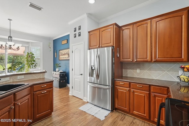 4956 Cypress Links Blvd, Elkton, FL 32033 - kitchen featuring stainless steel fridge, black / electric stove, dark countertops, ornamental molding, and tasteful backsplash