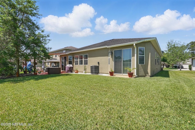 4956 Cypress Links Blvd, Elkton, FL 32033 - rear view of property with stucco siding, a yard, and central air condition unit