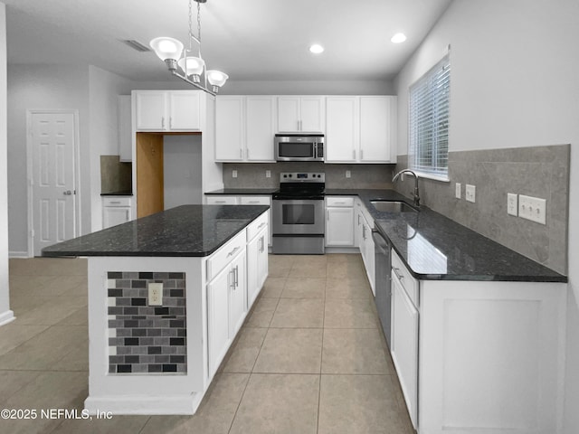 3124 Hidden Lake Cv, Middleburg, FL 32068 - kitchen featuring stainless steel appliances, a sink, backsplash, dark stone countertops, and recessed lighting