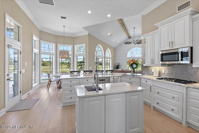 201 Royal Tern Rd N, Ponte Vedra Beach, FL 32082 - kitchen featuring gas stovetop, stainless steel microwave, a chandelier, a sink, and light countertops