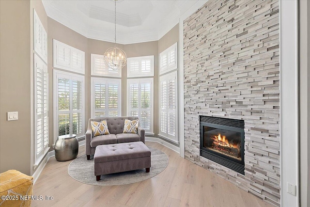 201 Royal Tern Rd N, Ponte Vedra Beach, FL 32082 - living area with ornamental molding, wood finished floors, a stone fireplace, a high ceiling, and a raised ceiling