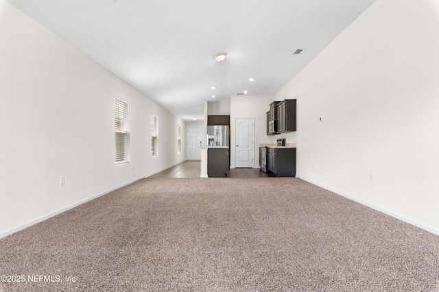 8244 Meadow Walk Ln, Jacksonville, FL 32256 - unfurnished living room featuring carpet floors, vaulted ceiling, baseboards, and recessed lighting