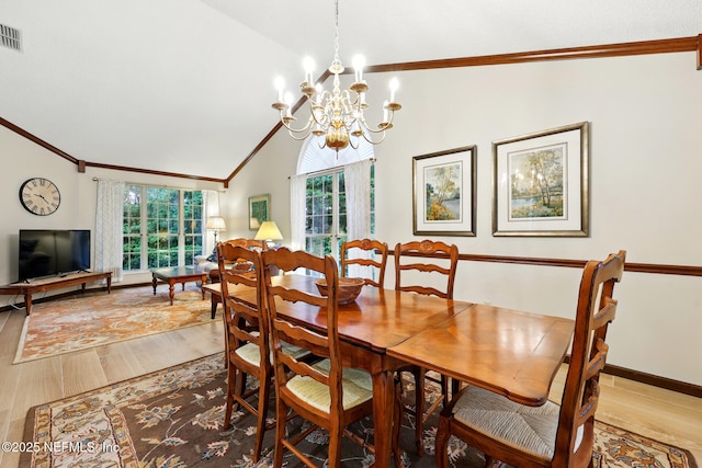 1917 Lakeside Dr S, Fernandina Beach, FL 32034 - dining area featuring wood finished floors, vaulted ceiling, crown molding, a chandelier, and baseboards