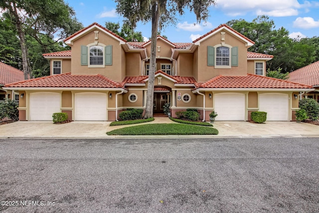 95050 Barclay Pl Unit 5B, Fernandina Beach, FL 32034 - mediterranean / spanish home with concrete driveway, an attached garage, and stucco siding