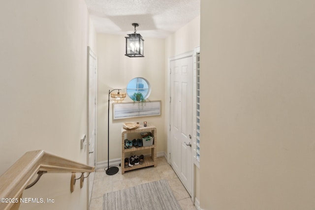95050 Barclay Pl Unit 5B, Fernandina Beach, FL 32034 - doorway to outside with tile patterned floors, a textured ceiling, and baseboards