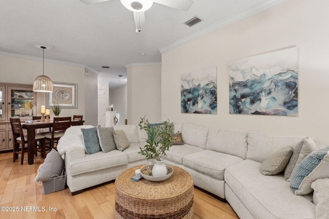 95050 Barclay Pl Unit 5B, Fernandina Beach, FL 32034 - living area with ornamental molding, light wood-style flooring, and ceiling fan