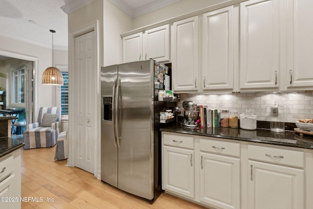 95050 Barclay Pl Unit 5B, Fernandina Beach, FL 32034 - kitchen featuring stainless steel refrigerator with ice dispenser, crown molding, tasteful backsplash, white cabinetry, and light wood-style floors