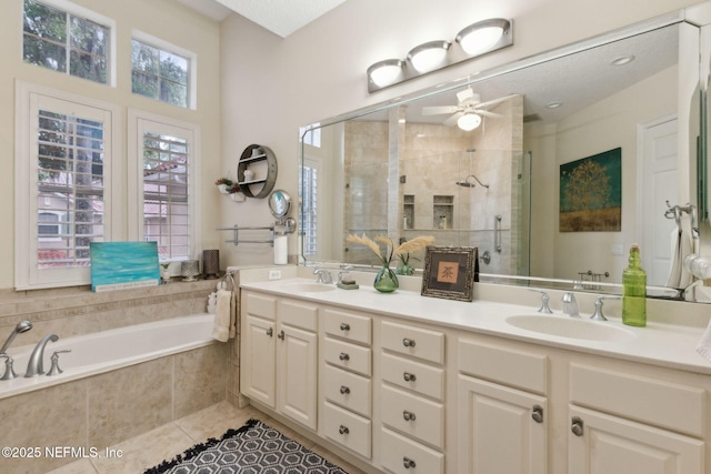 95050 Barclay Pl Unit 5B, Fernandina Beach, FL 32034 - bathroom featuring a stall shower, double vanity, a bath, a ceiling fan, and tile patterned floors