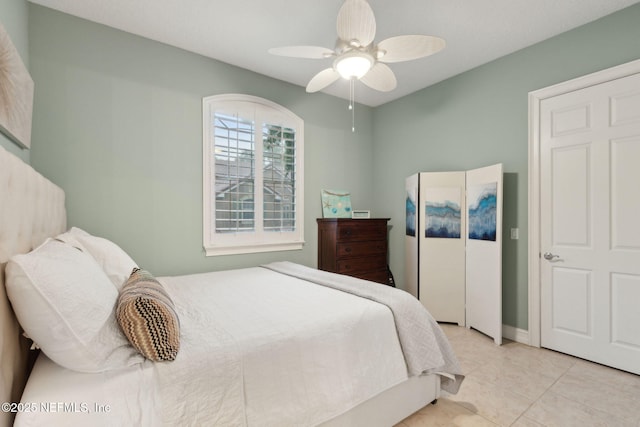 95050 Barclay Pl Unit 5B, Fernandina Beach, FL 32034 - bedroom with light tile patterned floors and ceiling fan