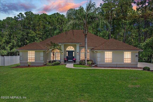 mediterranean / spanish house featuring stucco siding and roof with shingles