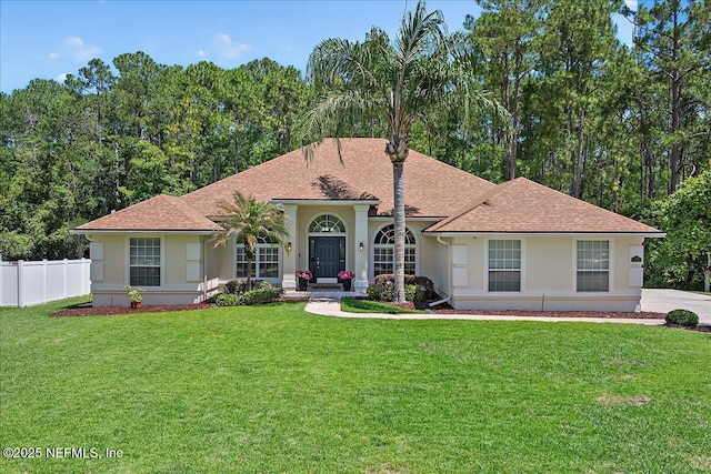 mediterranean / spanish-style house with stucco siding and a shingled roof