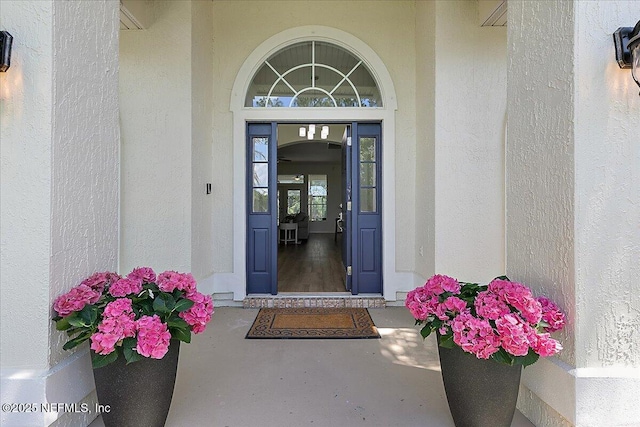 property entrance with stucco siding