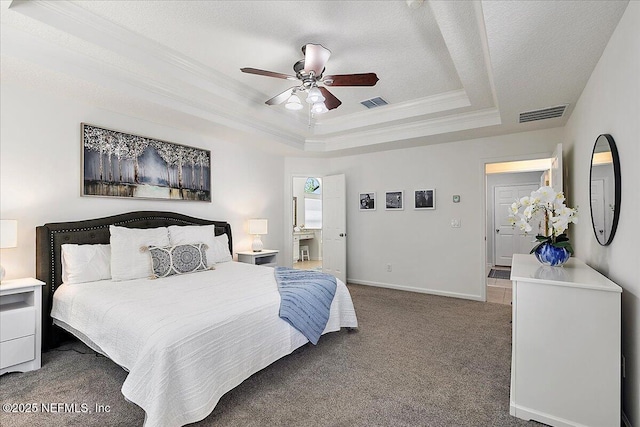 bedroom with carpet, a tray ceiling, ornamental molding, baseboards, and ceiling fan