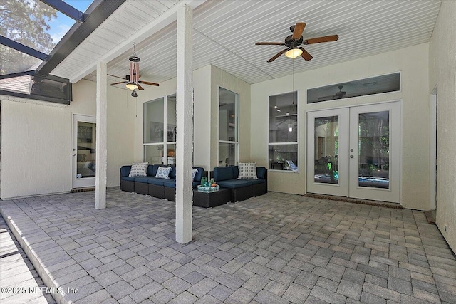view of patio / terrace with ceiling fan, french doors, an outdoor living space, and a lanai