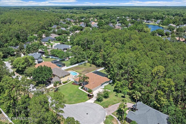 view of property location with a forest and a large body of water